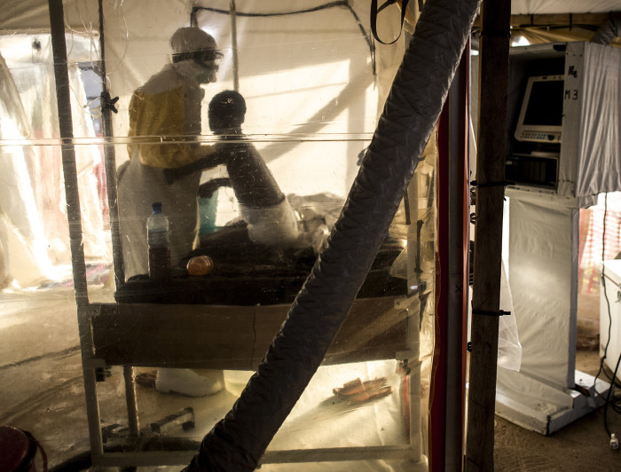 A Health worker tends to an Ebola Patient Kambale inside an Ebola Treatment Centre on July 14, 2019 in Beni.