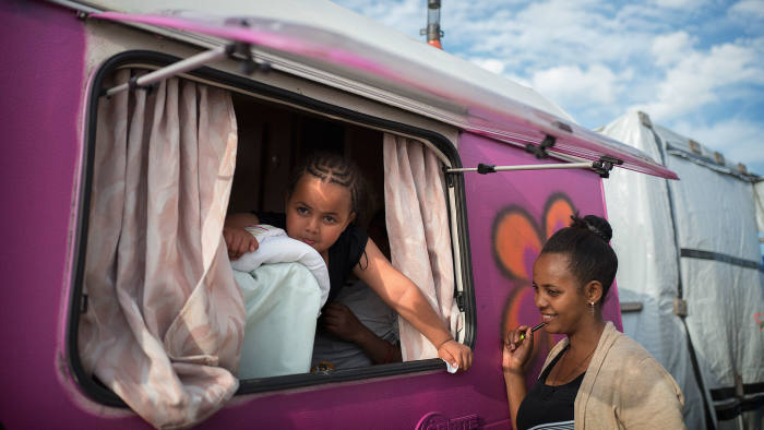 Yabsira’s daughter, left, in the caravan she shared with her mother in the Calais Jungle