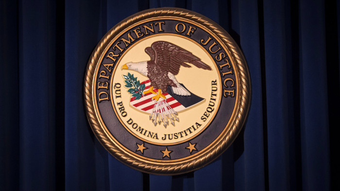 FILE PHOTO: The Department of Justice (DOJ) logo is pictured on a wall after a news conference in New York December 5, 2013. REUTERS/Carlo Allegri/File Photo