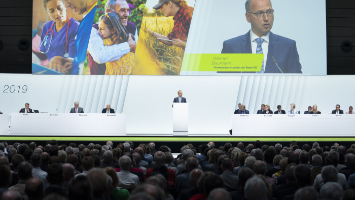 Werner Baumann, chief executive officer of Bayer AG, center, speaks during the company's annual general meeting in Bonn, Germany, on Friday, April 26, 2019. Baumann faces the biggest test of his three-year tenure as shareholders increasingly upset with the Monsanto takeover gather for a day-long meeting that will culminate in a crucial confidence vote. Photographer: Jasper Juinen/Bloomberg