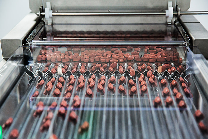 Metformin pills move through a sorting machine at a Laurus Labs Ltd. pharmaceutical plant in Visakhapatnam, Andhra Pradesh, India, on Wednesday, Nov. 15, 2017. Among the coconut plantations and beaches of South India, a factory the size of 35 football fields is preparing to churn out billions of generic pills for HIV patients and flood the U.S. market with the low-cost copycat medicines. Photographer: Sara Hylton/Bloomberg