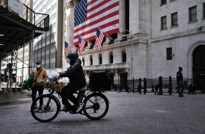 NEW YORK, NY - APRIL 02: A person rides a bike down Wall Street on April 02, 2020 in New York City. Hospitals in New York City, which has been especially hard hit by the coronavirus, are facing shortages of beds, ventilators and protective equipment for medical staff. Currently, over 92,000 people in New York state have tested positive for COVID-19. (Photo by Spencer Platt/Getty Images)