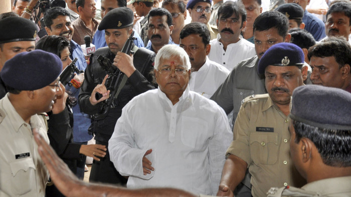 RJD Chief and a former chief minister of Bihar Yadav arrives at a court in Ranchi...Rashtriya Janata Dal (RJD) Chief and a former Bihar Chief Minister Lalu Prasad Yadav (C) arrives at a court in the eastern Indian city of Ranchi September 30, 2013. The prominent lawmaker allied with the Indian government was found guilty of corruption on Monday, a fresh blow for an administration that was widely lambasted last week for trying to protect convicted politicians in the run-up to elections. Yadav, from the poverty-ridden state of Bihar, will be sentenced on Thursday for his part in an 1990s animal fodder racket in which millions of dollars went missing from state coffers. REUTERS/Stringer (INDIA - Tags: POLITICS CRIME LAW)