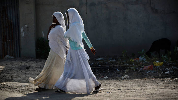 Two girls walk to school in the town of  Baga Sola, Chad Tuesday, Oct. 4, 2016.