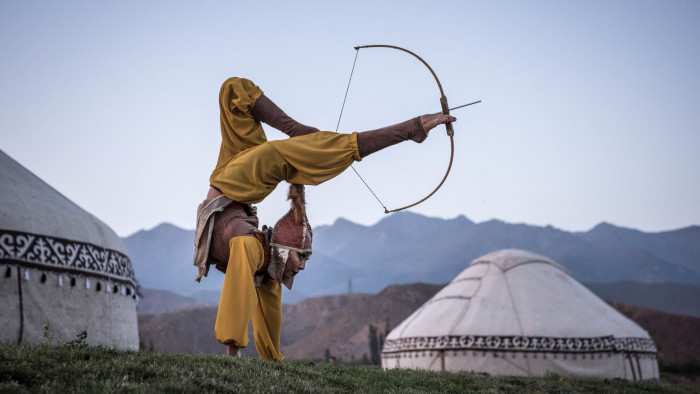 Aida Akmatova, a circus performer, shoots a bow and arrow with her feet at the World Nomad Games in Cholpon-ata, Kyrgyzstan, Sept. 4, 2018. Local participants reveled in the events; Akmatova also competed in horseback archery. &quot;This is not just another performance, but a key event in my life,&quot; she said. &quot;I can help pass down our culture, our traditions.&quot; (Sergey Ponomarev/The New York Times) Credit: New York Times / Redux / eyevine For further information please contact eyevine tel: +44 (0) 20 8709 8709 e-mail: info@eyevine.com www.eyevine.com