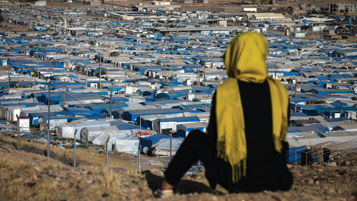 A woman looks out over the Kawergosk refugee camp, northern Iraq