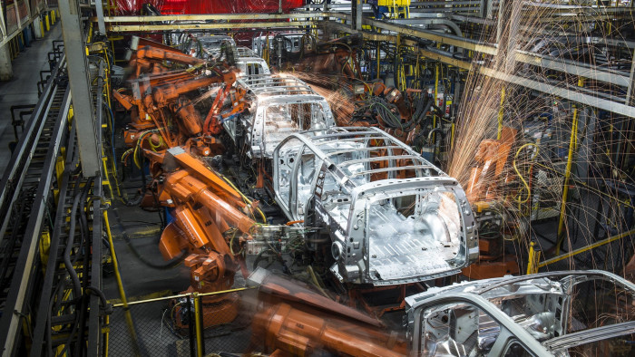 Robotic machines weld together the frames of sports utility vehicles (SUV) during production at the General Motors Co. (GM) assembly plant in Arlington, Texas, U.S., on Thursday, March 10, 2016. The U.S. Census Bureau is scheduled to release business inventories figures on March 15. Photographer: Matthew Busch/Bloomberg