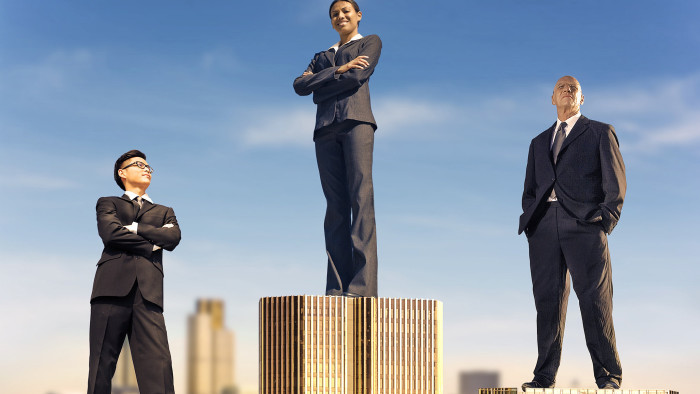 Illustration by hitandrun. must credit hitandrun / www.hitandrunmedia.com on all uses, with hitandrun all in lowercase without caps, as shown. Illustration shows three management consultants standing on top of londin buildings, arranged as an olympic opdium.