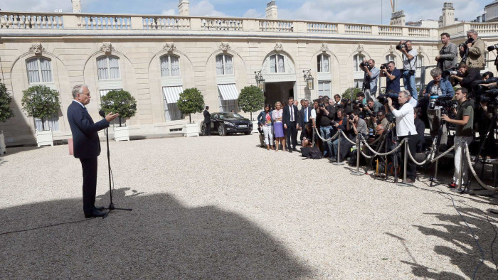 French Prime Minister Jean-Marc Ayrault delivers a speech in front of journalists outside the Elysee Palace