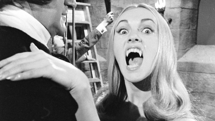 1970:  A female vampire played by Ingrid Pitt prepares to sink her fangs into a willing victim in the Hammer horror film 'The Vampire Lovers', directed by Roy Ward Baker.  (Photo via John Kobal Foundation/Getty Images)