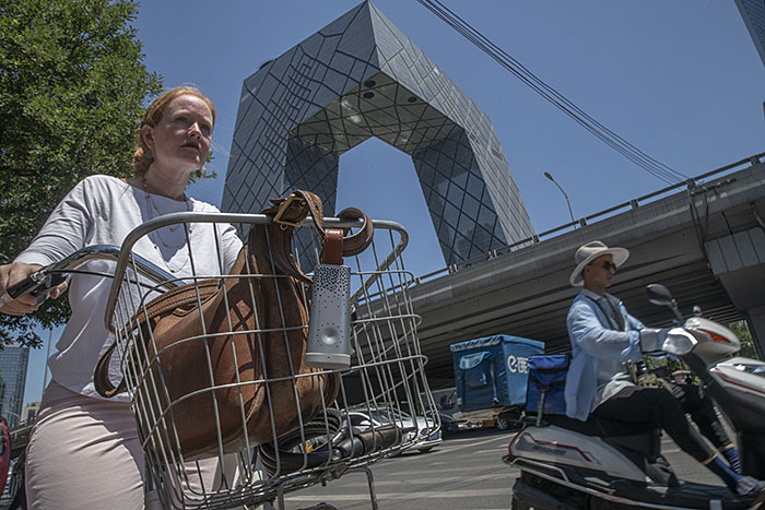 Lucy Hornby cycling near the CCTV headquarters in Beijing’s Central Business District