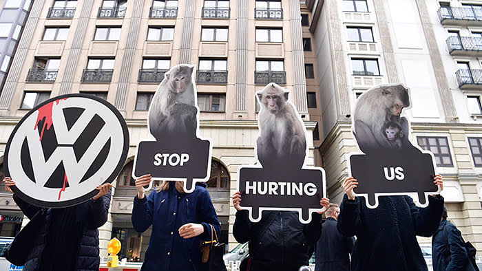 Protesters hold up posters with the logo of Volkswagen (VW) and of monkeys as they protest against animal testing in front of VW's showrooom, the venue where the German car maker is holding its annual press conference, in Berlin on March 13, 2018. Volkswagen holds its annual media conference at a time when the German auto sector is grappling with the threat of diesel driving bans, protectionist tariffs in the US and the fallout from the use of monkeys in exhaust tests. / AFP PHOTO / John MACDOUGALL (Photo credit should read JOHN MACDOUGALL/AFP/Getty Images)