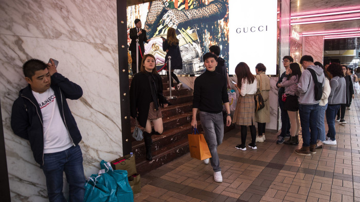 Shoppers wait in line outside a Guccio Gucci SpA store on Canton Road in the Tsim Sha Tsui district of Hong Kong, China, on Thursday, Dec. 20, 2018. Hong Kong's consumer price index (CPI) for November rose 2.6 percent year on year. Photographer: Justin Chin/Bloomberg