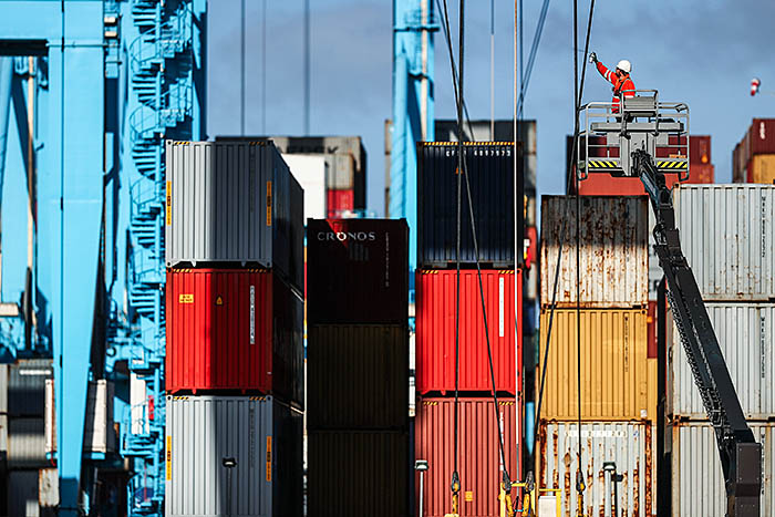 ROTTERDAM, NETHERLANDS - OCTOBER 27: A general view of workers in the yard working on shipping containers and the cranes which move them at the Port of Rotterdam on October 27, 2017 in Rotterdam, Netherlands. The Port of Rotterdam is the largest port in Europe covering 105 square kilometres or 41 sqaure miles and stretches over a distance of 40 kilometres or 25 miles. Its one of the busiest ports in the world handling thousands of cargo containers on a daily basis. (Photo by Dean Mouhtaropoulos/Getty Images)