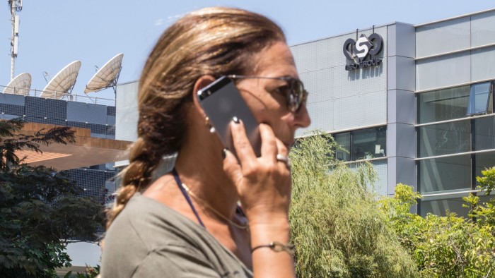 An Israeli woman uses her iPhone in front of the building housing the Israeli NSO group, on August 28, 2016, in Herzliya, near Tel Aviv. Apple iPhone owners, earlier in the week, were urged to install a quickly released security update after a sophisticated attack on an Emirati dissident exposed vulnerabilities targeted by cyber arms dealers. Lookout and Citizen Lab worked with Apple on an iOS patch to defend against what was called &quot;Trident&quot; because of its triad of attack methods, the researchers said in a joint blog post. Trident is used in spyware referred to as Pegasus, which a Citizen Lab investigation showed was made by an Israel-based organization called NSO Group. / AFP / JACK GUEZ (Photo credit should read JACK GUEZ/AFP/Getty Images)