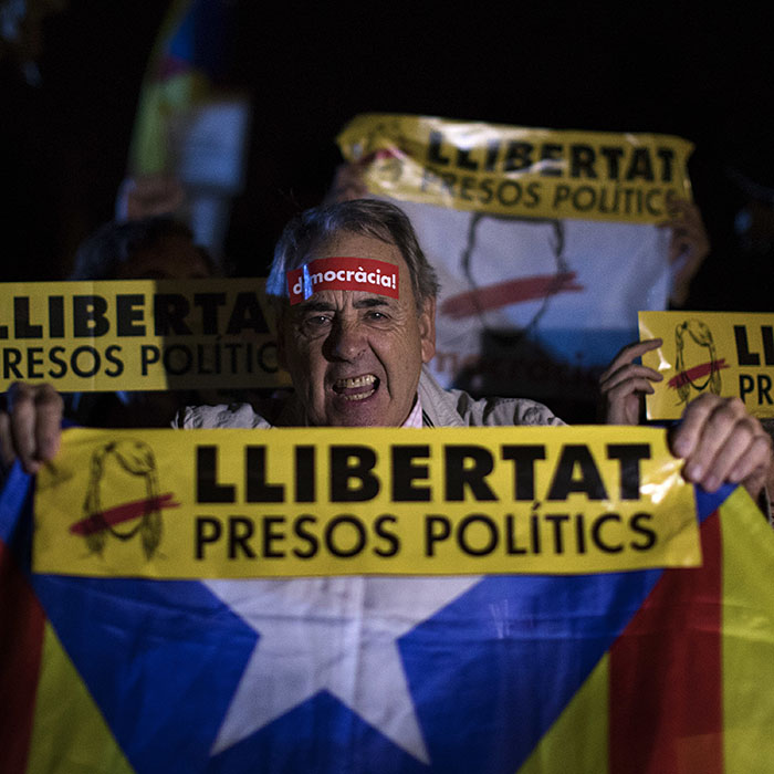 Demonstrators holding banners reading in Catalan &quot;freedom for the political prisoners&quot; gather outside the Catalonian Parliament to protest against the decision of a judge to jail ex-members of the Catalan government, in Barcelona, Spain, Thursday, Nov. 2, 2017. A Spanish judge has ordered nine ex-members of the government in Catalonia jailed while they are investigated on possible charges of sedition, rebellion and embezzlement. (AP Photo/Emilio Morenatti)