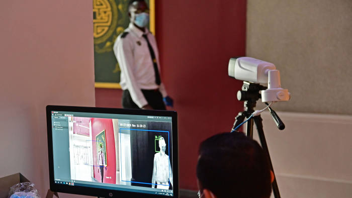 A security guard, wearing protective masks to prevent the spread of the coronavirus, walks infront of a thermal camera at the Ibn Battuta mall in the Emirate of Dubai on April 27, 2020. - The United Arab Emirates decided on April 23 to reopen malls, cafes and restaurants and ease lockdown restrictions imposed last month to prevent the spread of coronavirus on the occasion of Ramadan. (Photo by GIUSEPPE CACACE / AFP) (Photo by GIUSEPPE CACACE/AFP via Getty Images)