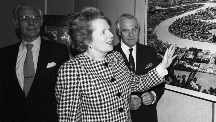 Prime Minister Margaret Thatcher discusses an artist's impression of future development in the dockland area with Chris Benson, Chairman of the London Docklands Development Corporation at it's headquarters in London. Also pictures (l) is Denis Thatcher.