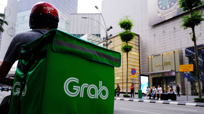 A Grab Holdings Inc. driver waits for an order in the Bukit Bintang district of Kuala Lumpur, Malaysia, on Monday, Jan. 6, 2020. Ringgit is poised for its first advance in three sessions, after overseas investors scooped up Malaysian stocks and the risk-off mood in global markets eased. Photographer: Samsul Said/Bloomberg