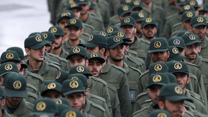 FILE - In this Feb, 11, 2019 file photo, Iranian Revolutionary Guard members arrive for a ceremony celebrating the 40th anniversary of the Islamic Revolution, at the Azadi, or Freedom, Square, in Tehran, Iran. President Donald Trump's administration is preparing to designate Iran's Revolutionary Guard as a "foreign terrorist organization." It's an unprecedented move that could have widespread implications for U.S. personnel and policy in the Mideast and elsewhere. U.S. officials say an announcement is expected Monday. (AP Photo/Vahid Salemi)