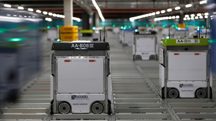 &quot;Bots&quot; are seen on the grid of the &quot;smart platform&quot; at the Ocado CFC (Customer Fulfilment Centre) in Andover, Britain May 1, 2018. Picture taken May 1, 2018.  REUTERS/Peter Nicholls