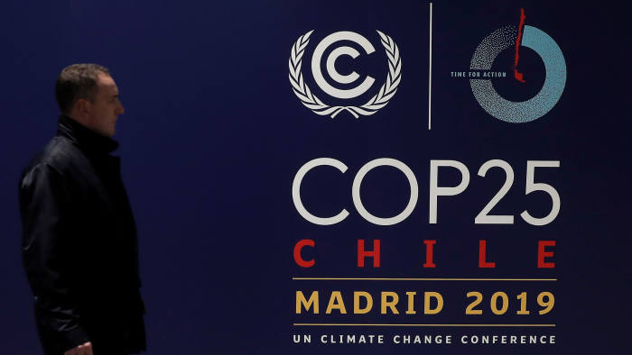 MADRID, SPAIN - NOVEMBER 29: A man walks past a COP25 poster ahead of the United Nations' COP25 climate change summit from 2- 13 December following Chile's withdrawal, as the last preparations continue at the IFEMA fairground in Madrid, Spain on November 29, 2019. (Photo by Burak Akbulut/Anadolu Agency via Getty Images)