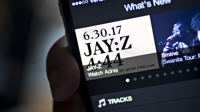 The Tidal application is demonstrated for a photograph on an Apple Inc. iPhone in Washington, D.C., U.S., on Tuesday, June 27, 2017. Jay Z's new album,&quot;4.44,&quot; his first in four years, will be released on June 30 and will be available only to users of the music streaming service that the rapper co-owns along with Sprint Corp. who has a 33 percent stake in the service. Photographer: Andrew Harrer/Bloomberg