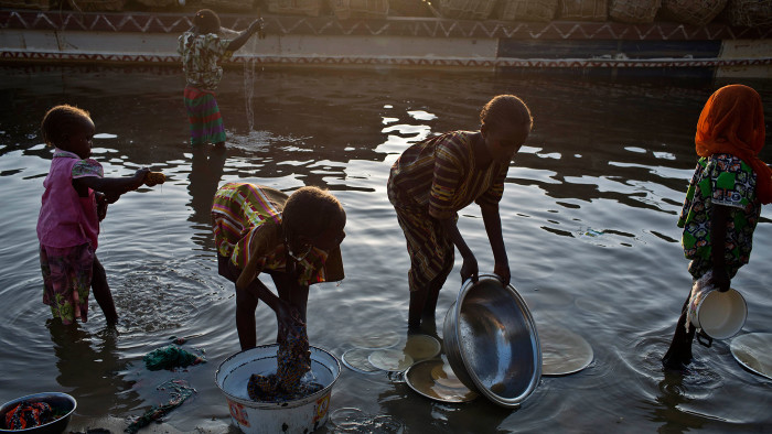 Girls use the waters of Lake Chad to do the washing
