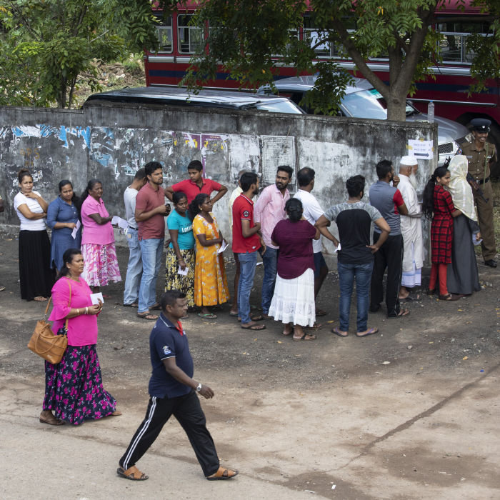 COLOMBO - NOVEMBER 16: Sri Lankan people wait in line to vote on Saturday to elect a new President in Colombo, Sri Lanka on November 16, 2019. In the early morning gunmen opened fire on a bus carrying Muslim voters, no injuries were reported in the incident before polls opened. The country is still recovering from the April, Easter Sunday bombings that killed 250 people. This election is seen as a test of the future stability of the country in a tight race with front runners Gotabaya Rajapaksa and Sajith Premadasa. (Photo by Paula Bronstein/Getty Images)