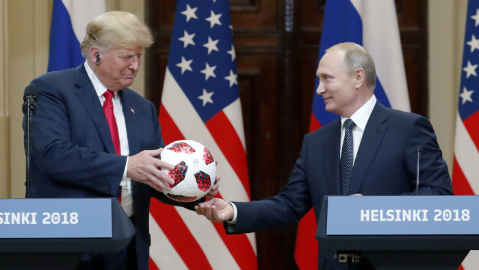 epaselect epa06893293 US President Donald J. Trump (L) receivs a soccer ball of the 2018 FIFA World Cup from Russian President Vladimir Putin (R) during a joint press conference in the Hall of State at Presidential Palace following their summit talks, in Helsinki, Finland, 16 July 2018. EPA/ANATOLY MALTSEV