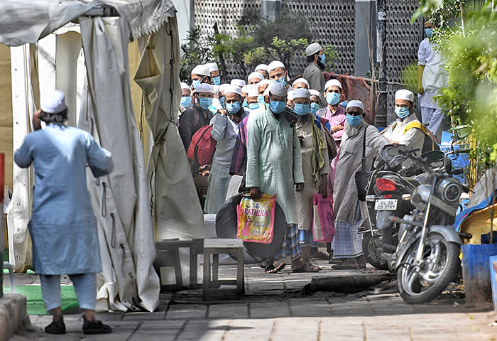 NEW DELHI, INDIA - MARCH 31: People who took part in a Tablighi Jamaat function earlier this month walk to board buses taking them to a quarantine facility amid concerns of infection, on day 7 of the 21-day nationwide lockdown imposed by PM Narendra Modi to check the spread of coronavirus, at Nizamuddin West on March 31, 2020 in New Delhi, India. Delhi Chief Minister Arvind Kejriwal ordered a police case against the Markaz Nizamuddin administration over negligence that has endangered lives. (Photo by Biplov Bhuyan/Hindustan Times via Getty Images)