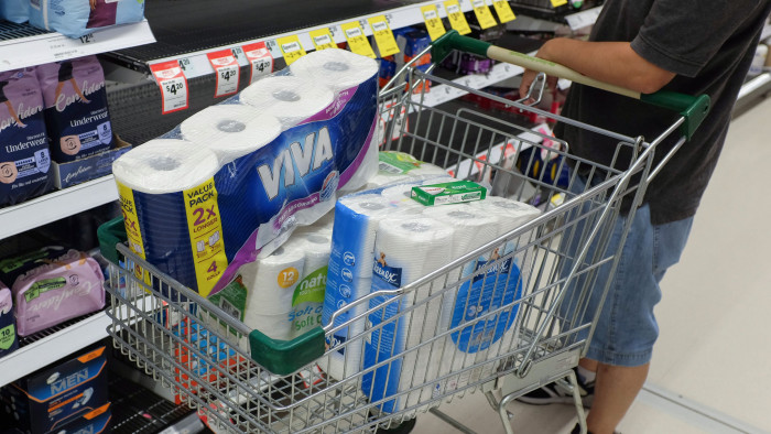 A customer holds a shopping cart filled with toilet and kitchen paper at a supermarket in Sydney, Australia, on Wednesday, March 4, 2020. Australia's four biggest lenders have heeded the prime minister’s plea to &quot;do their bit&quot; to help the country weather the expected economic hit from the coronavirus, by passing on the central bank’s latest interest-rate cut in full. Photographer: Brendon Thorne/Bloomberg