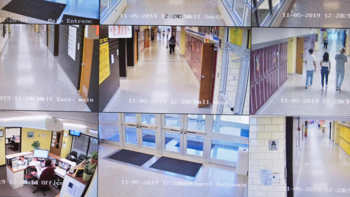 Video cameras monitor the halls of Sidney High School in the attendance office of the school in Sidney, Ohio, October 31, 2019. - At the entrance to Sidney High School in small-town Ohio, there is a poster which reads: &quot;Inside this building, our children are protected by an armed and trained response team.&quot; In rural Shelby County, law enforcement has trained teachers to fight back, should an attacker threaten students. They are among the first in the United States to embrace the controversial strategy. (Photo by Megan JELINGER / AFP) (Photo by MEGAN JELINGER/AFP via Getty Images)