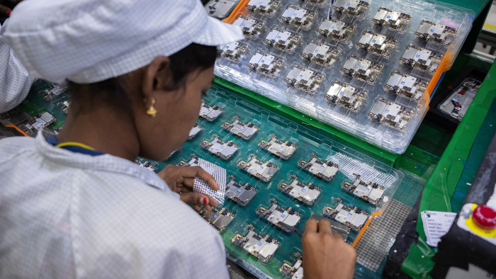 An employee assembles and inspects mobile phone parts at Rising Stars Mobile India Pvt. Ltd. at Sri City in the state of Andhra Pradesh in India on Thursday, 11th July, 2019. Photographer-Karen Dias/Bloomberg   An employee works at the factory of Rising Stars Mobile India Pvt., a unit of Foxconn Technology Co., in Sri City, Andhra Pradesh, India, on Thursday, July 11, 2019. Foxconn, also known as Hon Hai Precision Industry Co., opened its first India factory four years ago, it now operates two assembly plants with plans to expand those and open two more. The company was integral to China’s transformation into a manufacturing colossus, and founder Terry Gou has told India's Prime Minister Narendra Modi that Foxconn could help India do the same. Photographer: Karen Dias/Bloomberg
