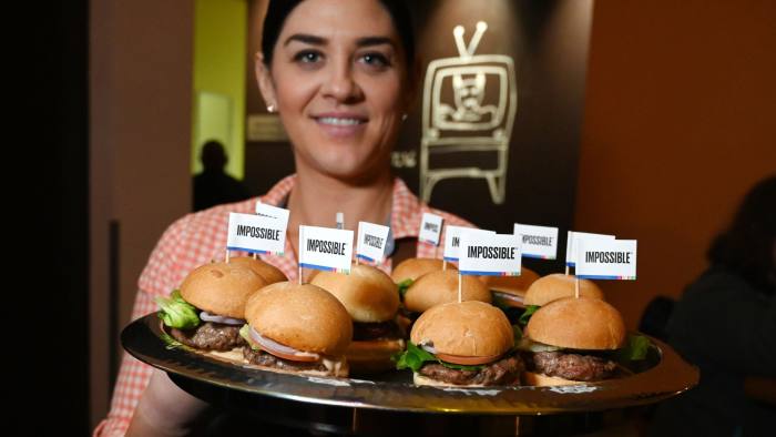 The Impossible Burger 2.0, the new and improved version of the company's plant-based vegan burger that tastes like real beef is introduced at a press event during CES 2019 in Las Vegas, Nevada on January 7, 2019. - The updated version can be cooked on a grill and has a better flavor and lowered cholesterol, fat and calories than the original. "Unlike the cow, we get better at making meat every single day," CEO of Impossible Foods CEO Pat Brown. (Photo by Robyn Beck / AFP)ROBYN BECK/AFP/Getty Images