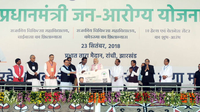 RANCHI, INDIA - SEPTEMBER 23: Prime Minister Narendra Modi gives a health card to beneficiaries as he launches Ayushman Bharat-National Health Protection Scheme, at Prabhat Tara Ground, at Dhurwa, on September 23, 2018 in Ranchi, India. Prime Minister Narendra Modi launched the Ayushman Bharat Pradhan Mantri Jan Aarogya Yojana (AB-PMJAY)' scheme, deemed as the world's largest government-funded healthcare programme covering over 50 crore beneficiaries. (Photo by Parwaz Khan/Hindustan Times via Getty Images)