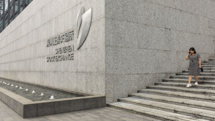 A woman walks down a flight of stairs at the Shenzhen Stock Exchange in Shenzhen, China, on Wednesday, Sept. 4, 2019. Shenzhen is young, hopeful and looks optimistically toward a future where it can help drive China’s push to dominate the next century through an innovative economy that sidesteps political freedoms. The city also has the centralized control, relentless efficiency and advanced manufacturing that lie at the root of President Xi Jinping’s concept of China’s future greatness. Photographer: Qilai Shen/Bloomberg