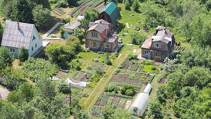 View from above to garden plots with cottages and greenhouses and garden beds