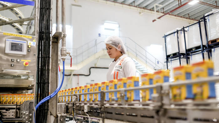 An employee monitors cartons of Chuckie, a Nestle SA chocolate flavored milk drink, moving along a conveyor at the company's factory in Batangas province, the Philippines, on Tuesday, April 2, 2019. Nestle Philippines targets to double production of its chocolate milk brand product with its new 2.8b-peso plant in Batangas province, chairman and CEOÂ Kais MarzoukiÂ says. Photographer: Veejay Villafranca/Bloomberg via Getty Images