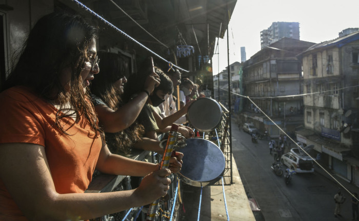 In response to the call of Prime Minister Narenda Modi, a group of women come out onto their apartment's balcony clapping and banging dishes in a display of thanks and support for the emergency services on the frontline fighting the coronavirus outbreak.