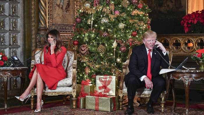 TOPSHOT - US President Donald J. Trump and the First Lady Melania Trump participate in NORAD Santa Tracker phone calls at the Mar-a-Lago resort in Palm Beach, Florida on December 24, 2017. (Photo by Nicholas Kamm / AFP) (Photo credit should read NICHOLAS KAMM/AFP/Getty Images)