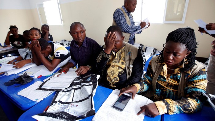 Congo's Independent National Electoral Commission (CENI) officials check presidential elections polling stations voting forms at tallying centre in Kinshasa, Democratic Republic of Congo, January 4, 2019. REUTERS/Baz Ratner