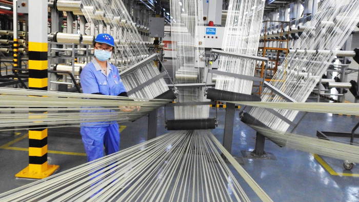 An employee works on a carbon fiber production line at a factory in Lianyungang in China's eastern Jiangsu province on August 9, 2018. - China's factory price inflation eased in July although beating expectations, official data showed on August 9, as China's retaliatory tariff against the US unlikely to translate into much price hike, analysts say. (Photo by STR / AFP) / China OUTSTR/AFP/Getty Images