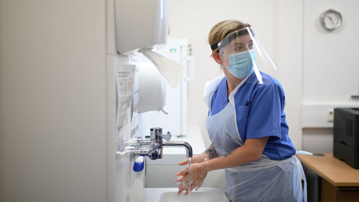 Nurse Ashleigh Smith wearing personal protective equipment (PPE) washes her hands at work at the Littlefield practice at Freshney Green Primary Care Centre in Grimsby, Britain June 9, 2020. Picture taken June 9, 2020. Daniel Leal-Olivas/Pool via REUTERS