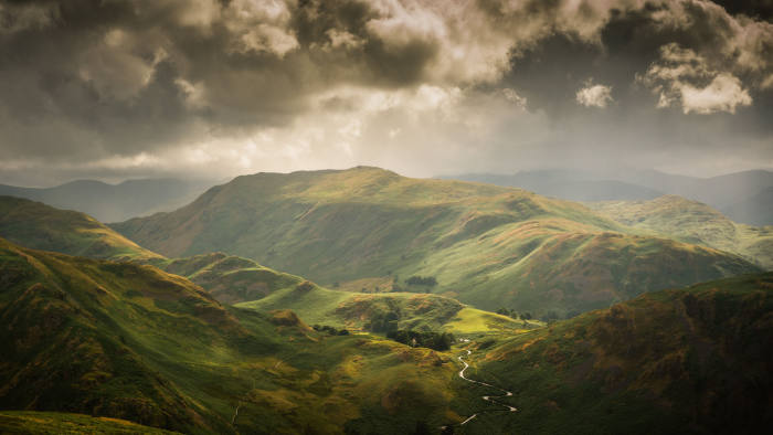 Taken from Bonscale Pike and is looking over the top of the Howtown Hotel and Naetindsle Hause. Steel Knotts is to the left with Beda Fell begins to the left and Place Fell straight ahead. At the back and barely visible through the cloud is Helvellyn and Catstycam. photographed by Mark Littlejohn Photography