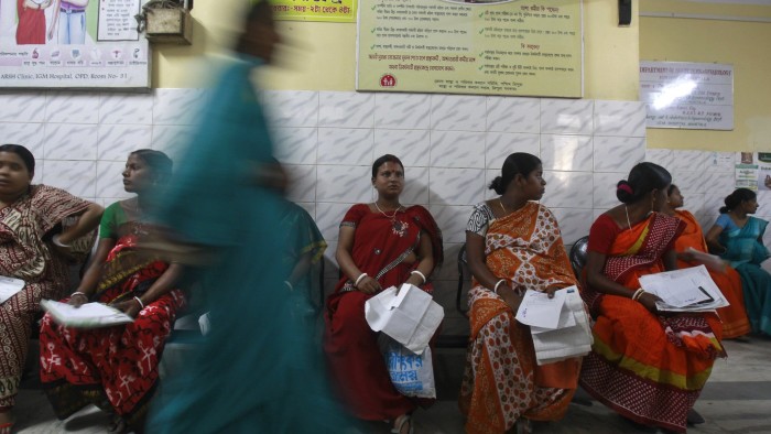 Pregnant women holding their prescription papers wait to be examined at a government-run hospital in the northeastern Indian city of Agartala March 17, 2015. India is betting on cheap mobile phones to cut some of the world's highest rates of maternal and child deaths, as it rolls out a campaign of voice messages delivering health advice to pregnant women and mothers. Amid a scarcity of doctors and public hospitals, India is relying on its mobile telephone network, the second largest in the world with 950 million connections, to reach places where health workers rarely go. REUTERS/Jayanta Dey (INDIA - Tags: HEALTH SCIENCE TECHNOLOGY) - GM1EB3H16TA01