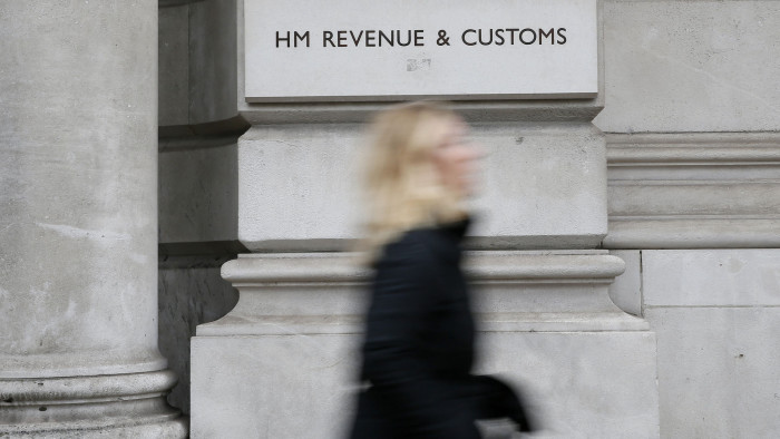 A pedestrian walks past the headquarters of Her Majesty's Revenue and Customs (HMRC) in central London February 13, 2015. British lawmakers plan to call up the bosses of HSBC and the tax authority, HMRC, to quiz them over allegations some clients of HSBC's Swiss private bank evaded tax.     REUTERS/Stefan Wermuth (BRITAIN - Tags: BUSINESS POLITICS CRIME LAW) - LM1EB2D127201