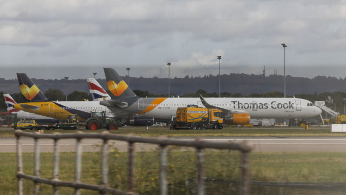 Passenger aircraft featuring the Thomas Cook Group Plc livery sit on the tarmac with aircraft featuring the British Airways livery at London Gatwick Airport near Crawley, U.K., on Monday, Sept. 23, 2019. Thomas Cook collapsed under a pile of debt after talks with creditors failed, forcing the British government to charter planes to bring home more than 150,000 of the storied travel provider’s stranded customers. Photographer: Chris Ratcliffe/Bloomberg