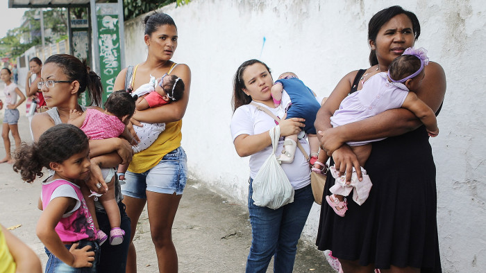 Mothers hold their infants, all born with microcephaly, after visiting a rehabilitation clinic in Recife