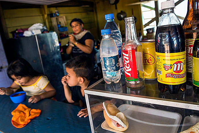 Children have breakfast next to a big offer of snacks and soft drinks, which can be seen in restaurants at the entrance of Careiro da Várzea city (in Amazonas state, Northern Brazil), on January, 10th, 2018. Bad eating habits are among the main causes of children obesity, which has already been considered pandemic. The condition affects children's development. Photo: FINANCIAL TIMES / RAPHAEL ALVES